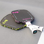 Two pickleball paddles with 'F+B' branding on a gray surface.